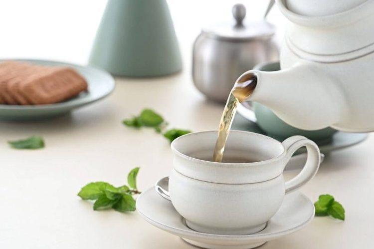 čaj od mente za želudac Čaj od mente za želudac u bijeloj šalici s listovima svježe mente